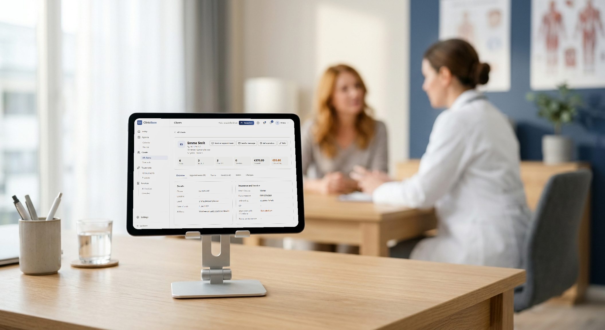 A consultation, with the client file in ClinicBase on a tablet